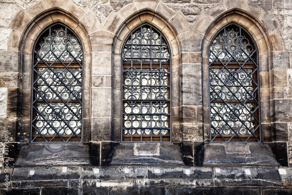 Old style windows on historic stone building Old style windows on historic stone building