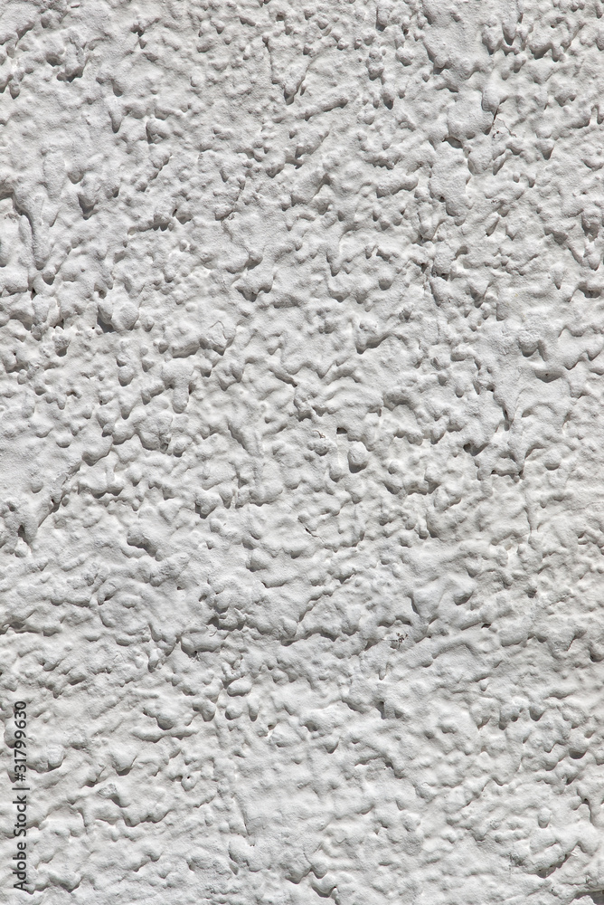 Vertical closeup of white plaster textured wall background