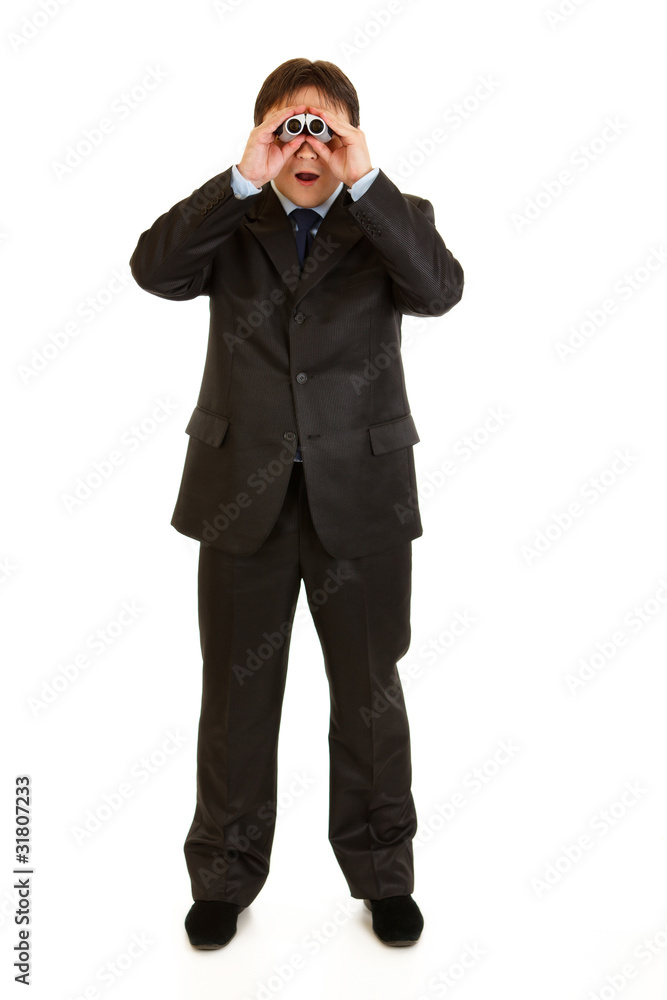 Full length portrait of businessman looking through binoculars Full length portrait of businessman looking through binoculars