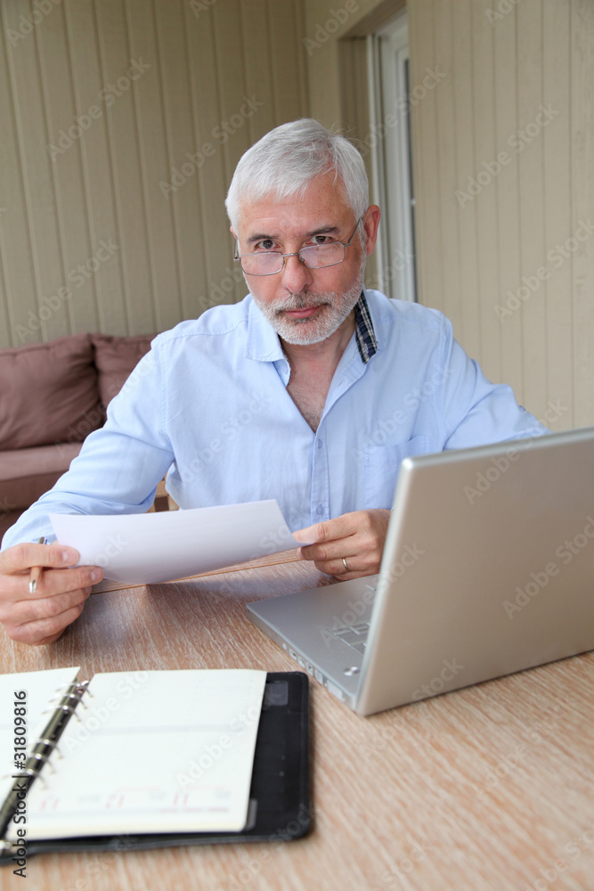 Senior businessman working at home Senior businessman working at home