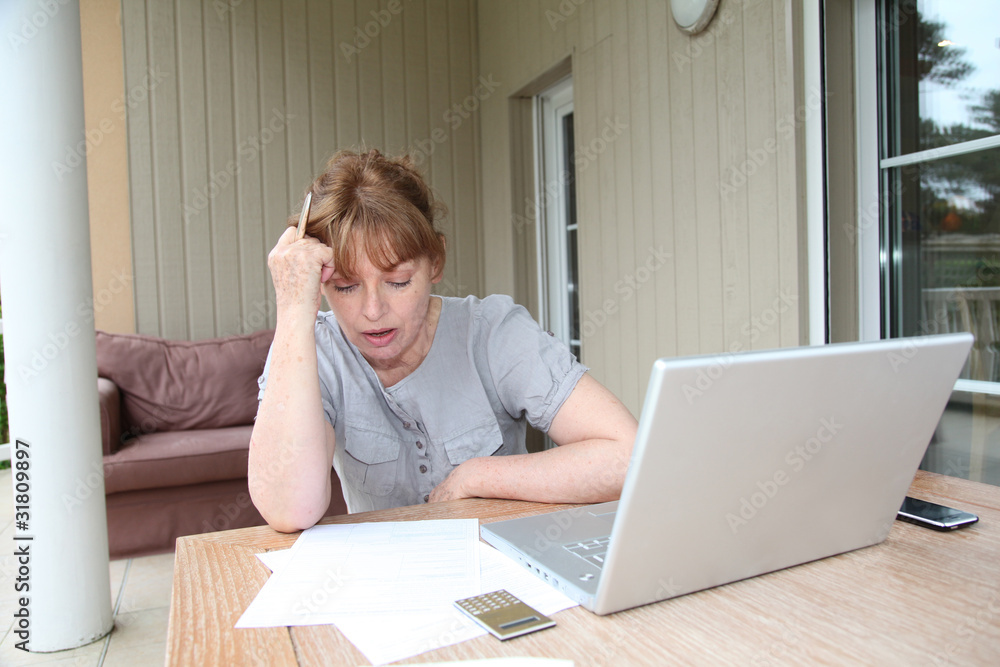 Senior woman having trouble with tax declaration Senior woman having trouble with tax declaration