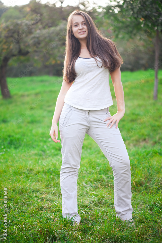 beautiful young woman standing on green grass beautiful young woman standing on green grass
