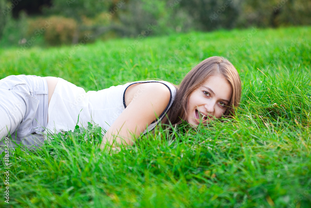 beautiful young woman lying on green grass beautiful young woman lying on green grass