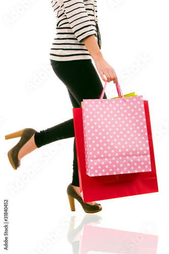 waist-down view of woman carrying shopping bags