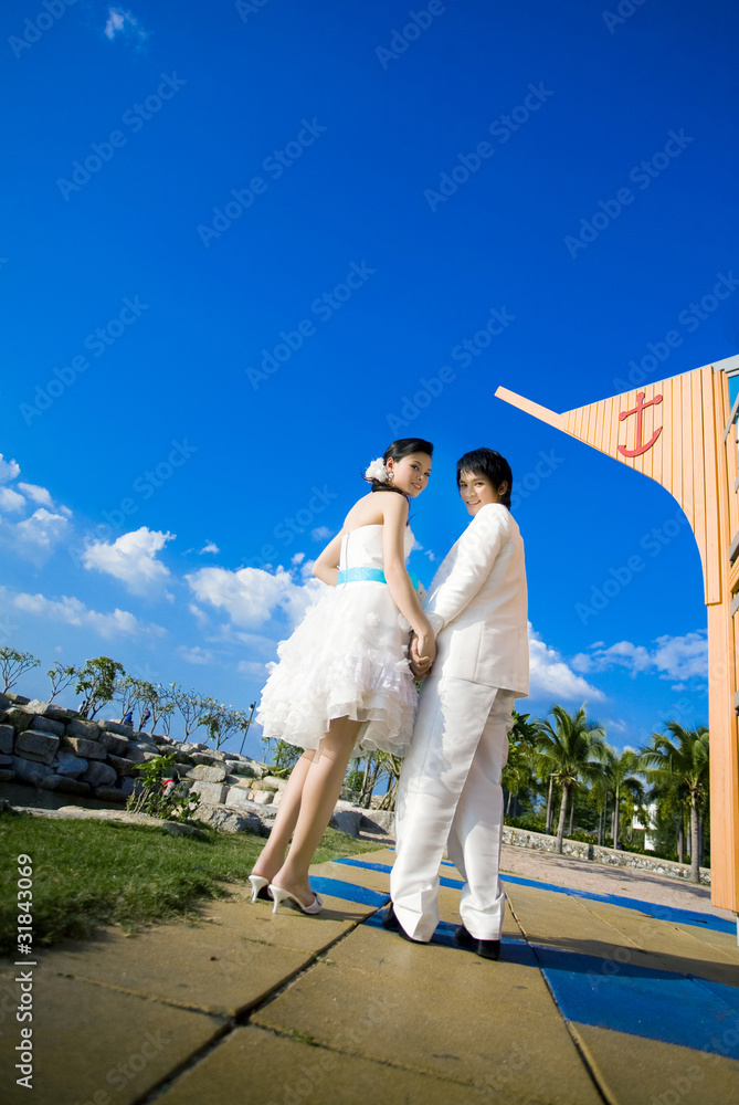 Bride and groom on the street and sky