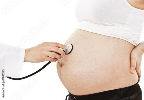 фотографія Pregnant woman being examine by a doctor with a stethoscope