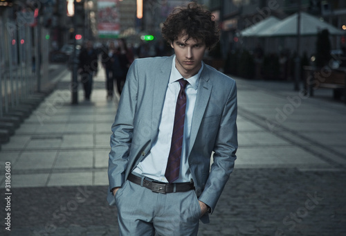 Wallpaper Mural Handsome guy walking on a evening city street Torontodigital.ca