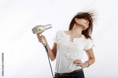 young beauty with hair drier photo