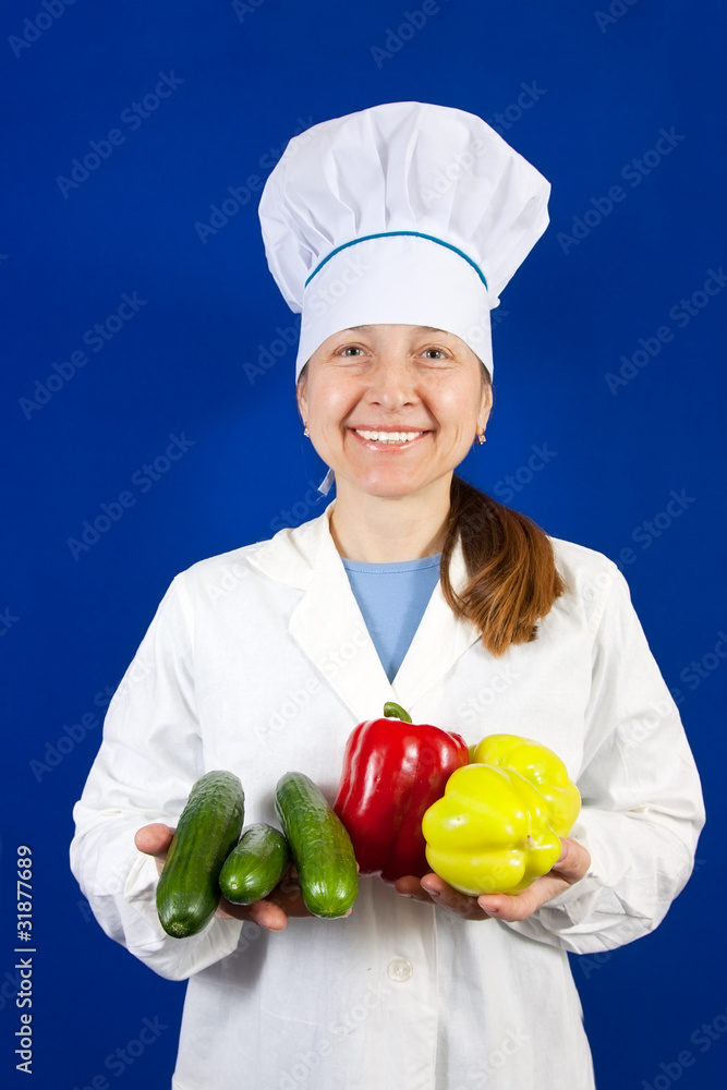 female cook in toque with vegetables female cook in toque with vegetables