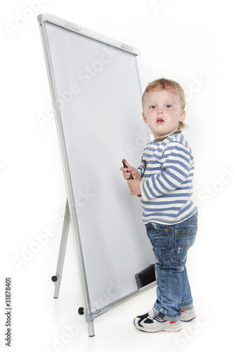 toddler boy next to white board