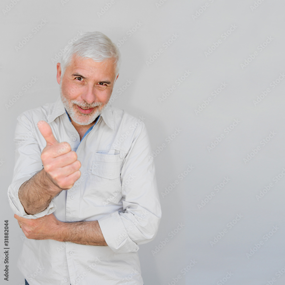 Senior man with thumbs up