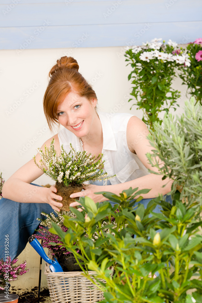 Summer garden terrace redhead woman hold flower Summer garden terrace redhead woman hold flower