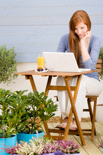 Obraz na płótnie Summer terrace redhead woman with laptop w salonie