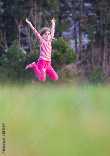 Young girl jumping outdoors