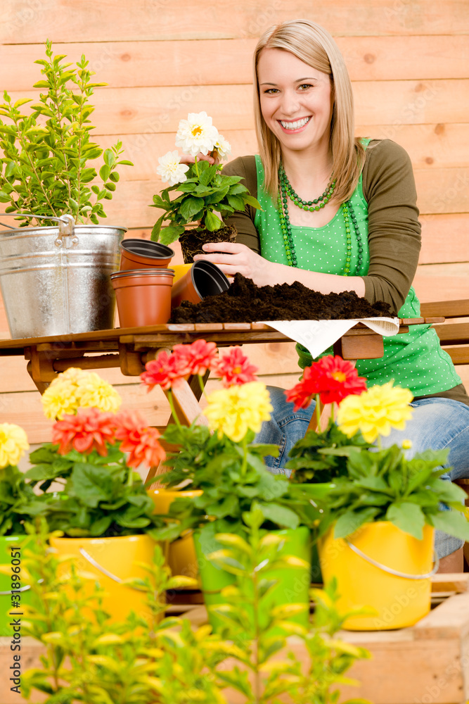 Gardening woman planting spring flower