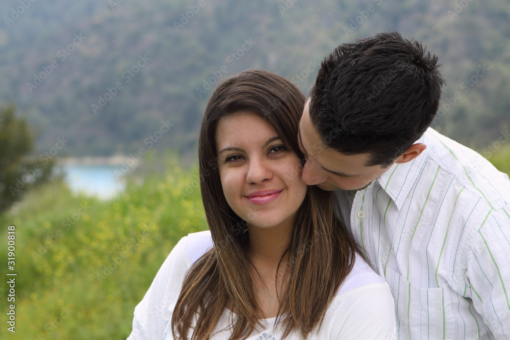 Obraz premium Man Snuggling and Kissing Attractive Woman