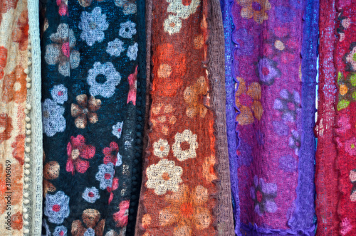 colorful patterned fabrics hanging in a row