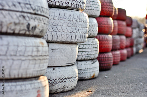 racetrack fence of white and red of old tires