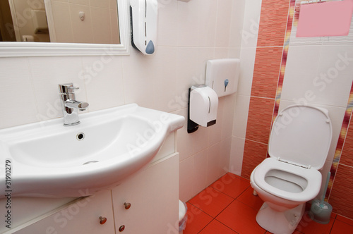 modern toilet interior in white and red colors