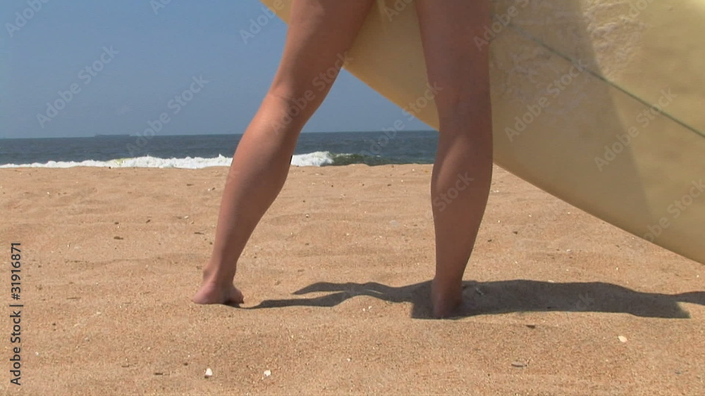 Young woman holding surf board at the beach Young woman holding surf board at the beach