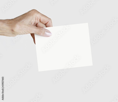 Female hand holding a blank notepape