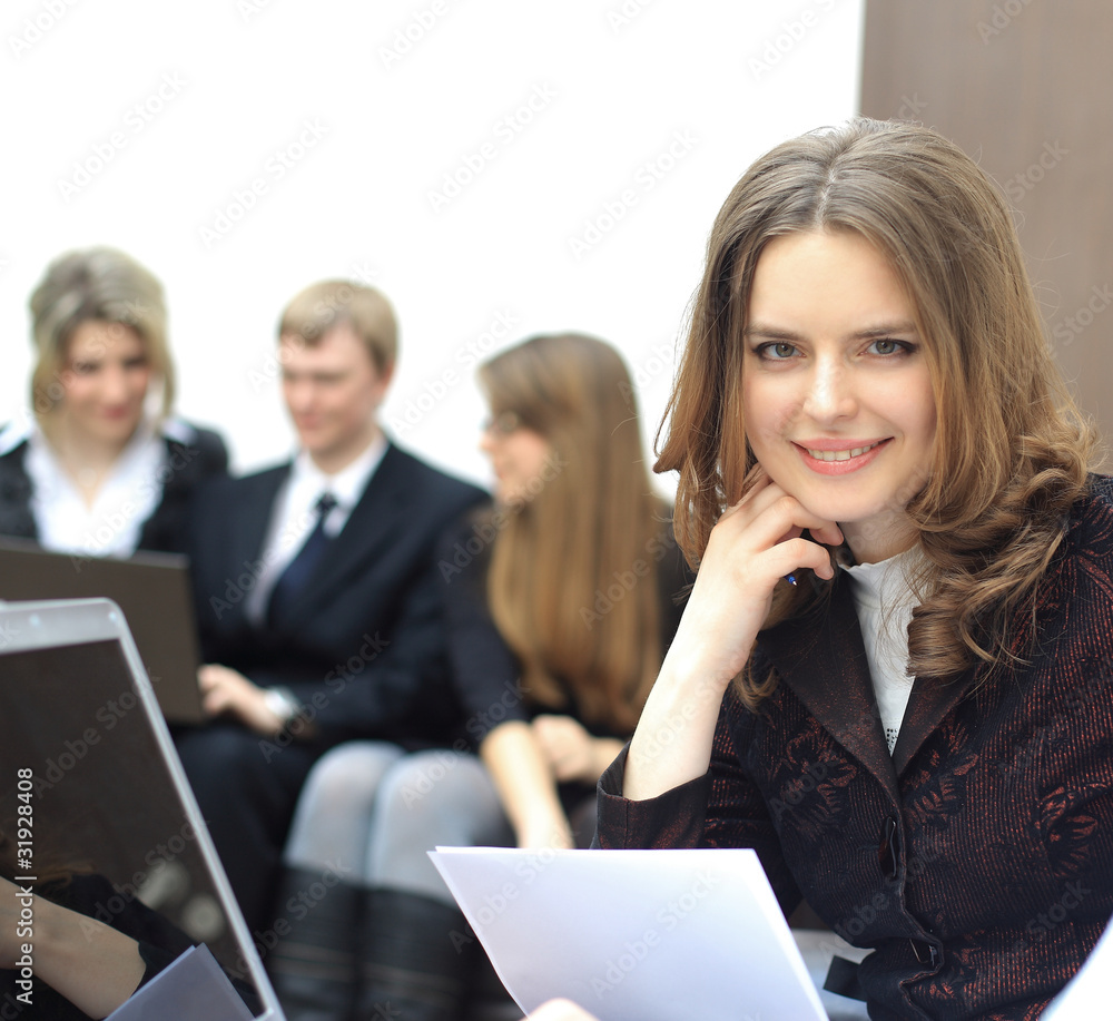 Portrait of a smart young businesswoman with people at Portrait of a smart young businesswoman with people at