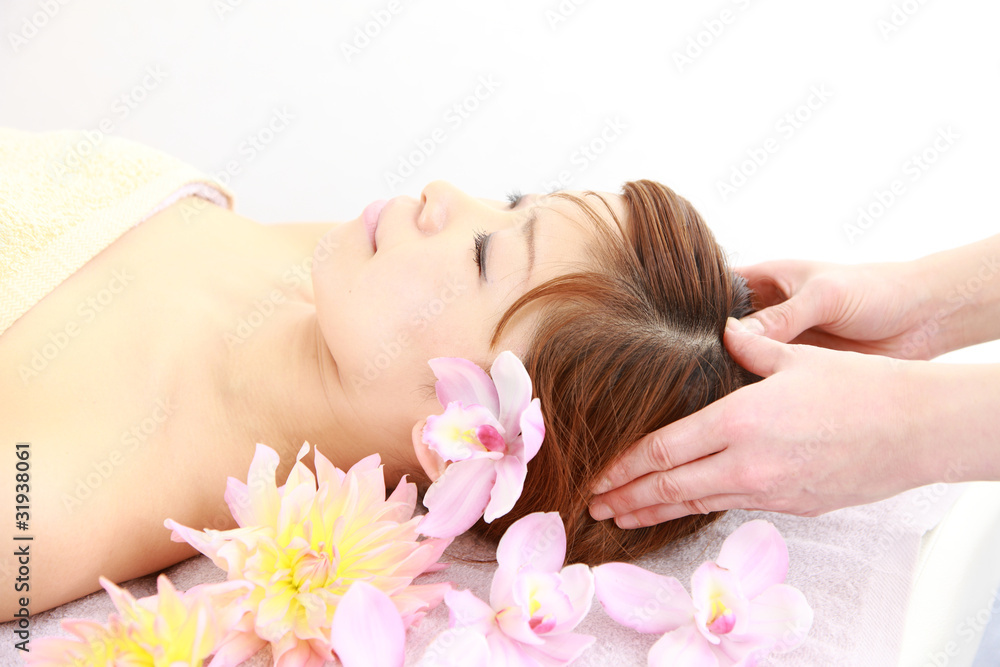 young japanese woman getting a head massage young japanese woman getting a head massage