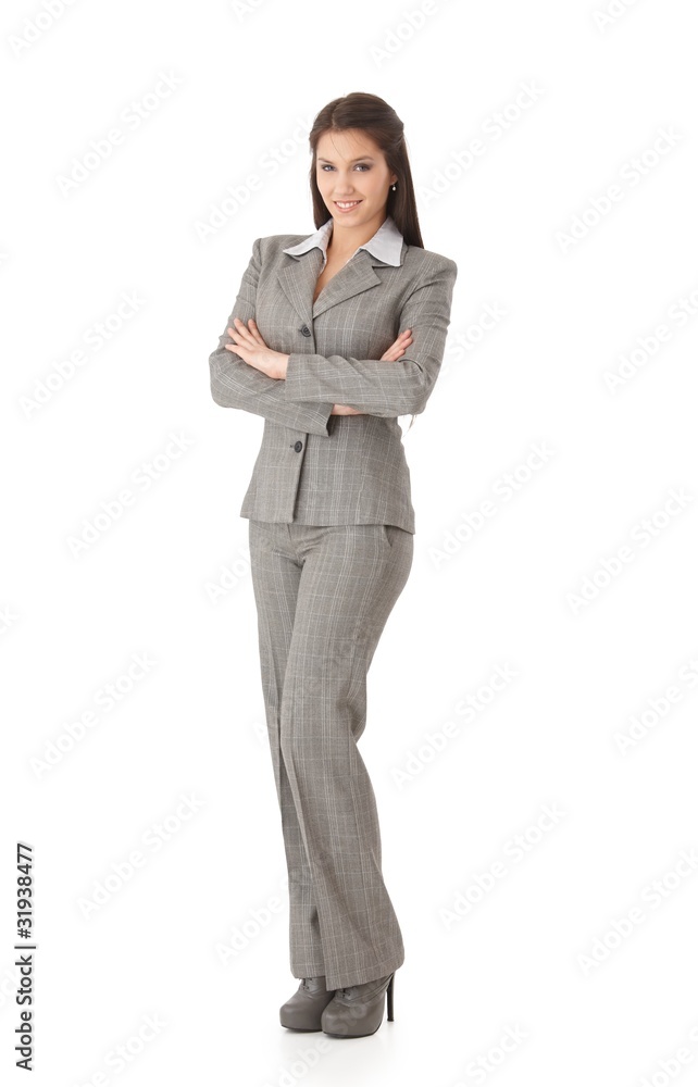 Young businesswoman standing arms crossed smiling Young businesswoman standing arms crossed smiling