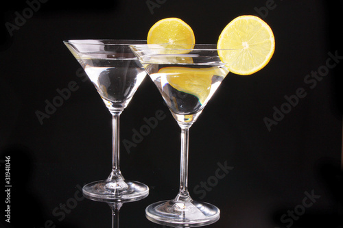 Martini glasses on black background