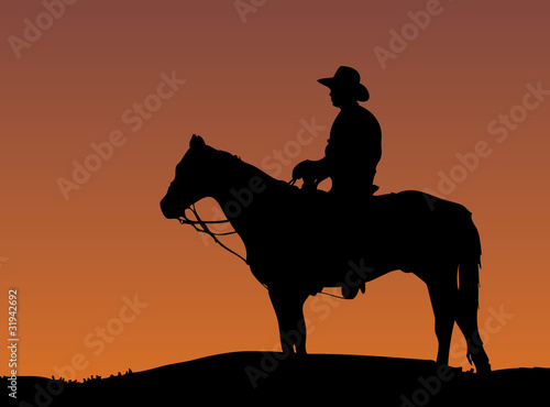 Cowboy on horse at sunset