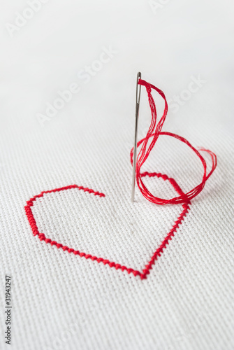 red heart with needle
