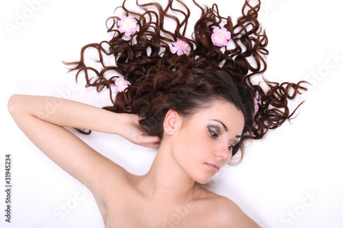 Brunette woman lying with flowers