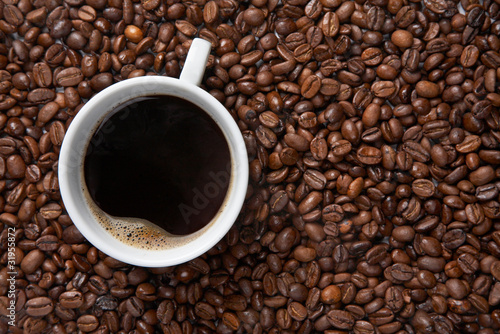 Coffee cup on background of beans