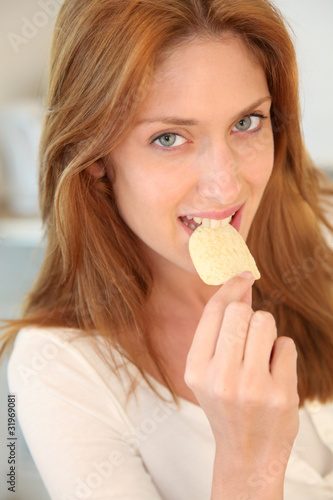 Portrait of woman eating potato chip