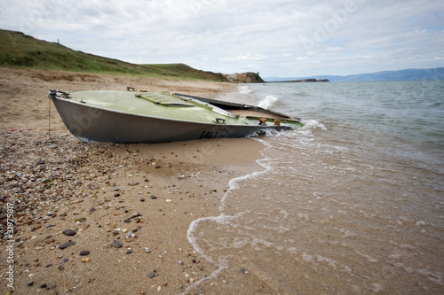 Abandoned boat on sand, Baikal lake coast, Olkhon island.