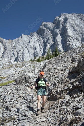 Woman Hiking On A Mountain Path