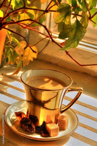 Coffee in glold cup with brown sugar photo