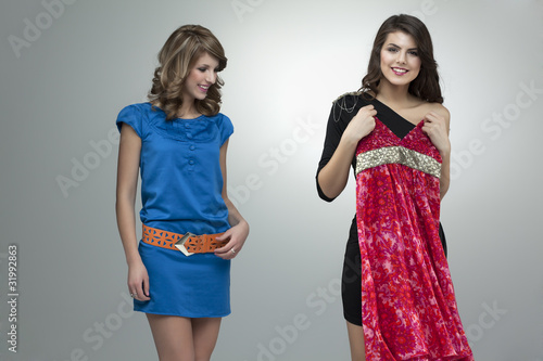 happy two women trying red flower dress photo