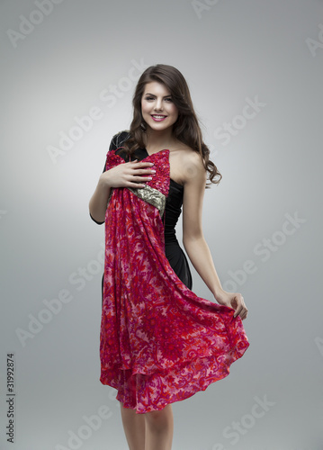 happy women trying red flower dress