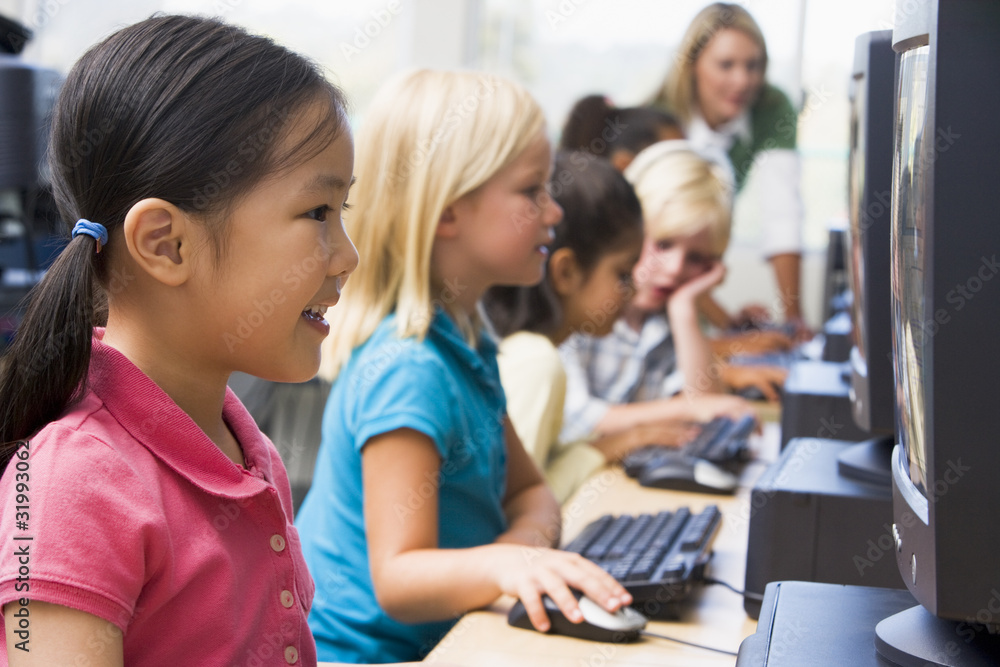 Kindergarten children learning how to use computers. Kindergarten children learning how to use computers.