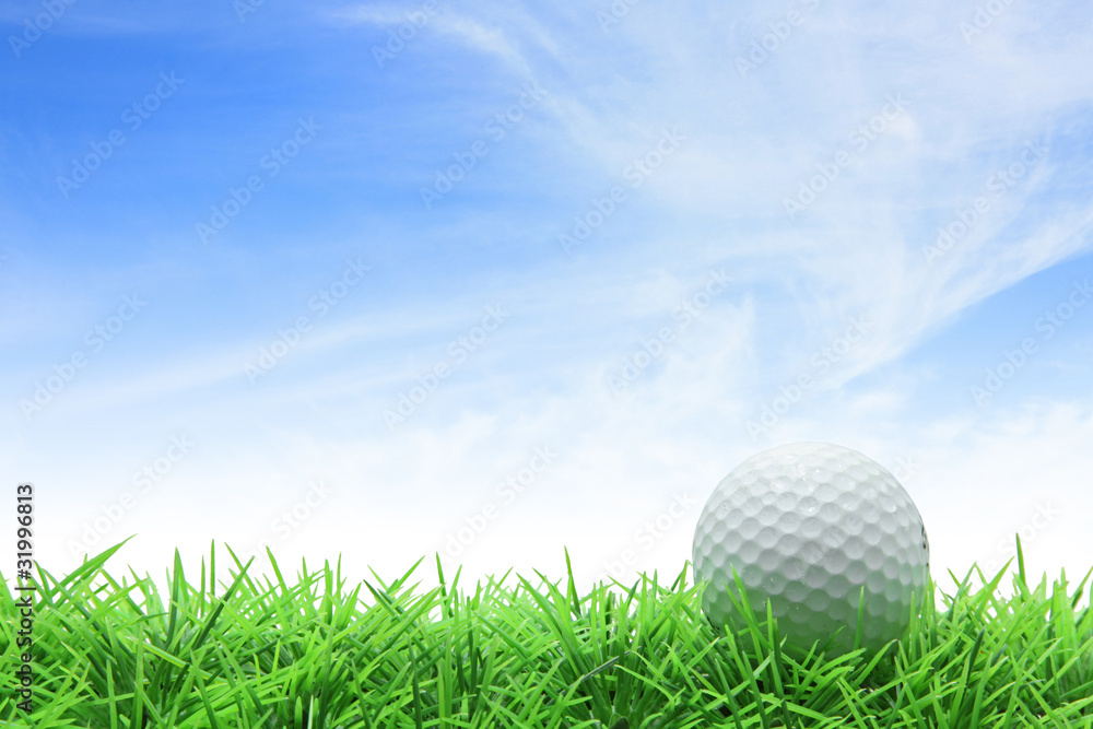 golf ball on green grass against blue sky golf ball on green grass against blue sky