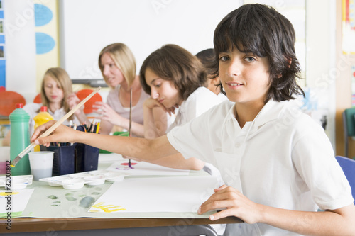 Schoolchildren and their teacher in an art class © Monkey Business