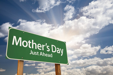 Mother's Day Green Road Sign Against Dramatic Sky and Clouds
