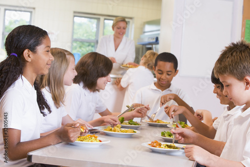 Schoolchildren enjoying their lunch in a school cafeteria