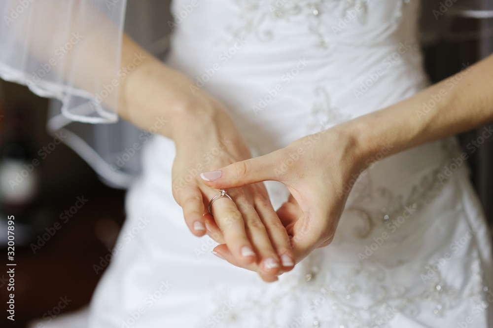 Bride adjusting her wedding or angagement ring Bride adjusting her wedding or angagement ring