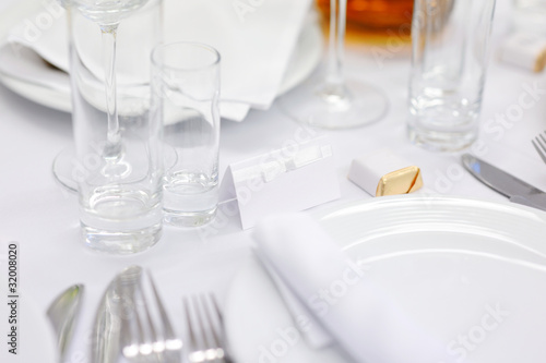 Empty place card at a wihite festive table