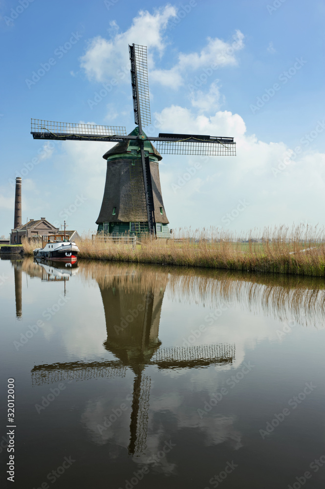 A traditional dutch windmill near the canal. Netherlands