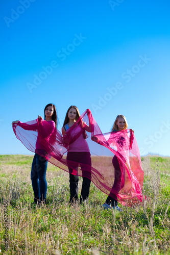 three young beautiful woman standing with tissue into the field