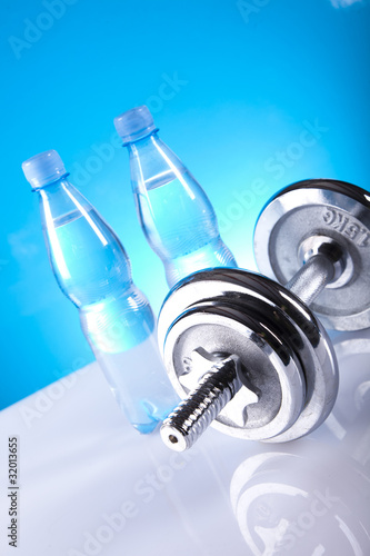 dumbell and bottles of mineral water