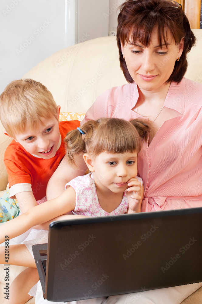 Mother with children at a laptop Mother with children at a laptop